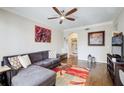 Comfortable living room with a ceiling fan, gray sectional, and warm hardwood floors at 3777 Peachtree Ne Rd # 722, Brookhaven, GA 30319