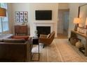 Comfortable living room with a fireplace, hardwood flooring, and neutral paint at 3636 Habersham Rd # 2307, Atlanta, GA 30305