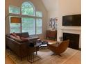 Modern living room boasts neutral color palette, fireplace and large windows at 3636 Habersham Rd # 2307, Atlanta, GA 30305
