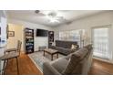 Cozy living room with ample seating, large window, ceiling fan, and access to the outdoor patio at 4007 Westchester Ne Rdg, Brookhaven, GA 30329