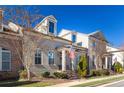 Beautiful townhouse exterior with brick and siding, American flag, and landscaped lawn at 7730 Pierpoint Ln, Alpharetta, GA 30005