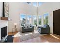 Bright living room with large windows, hardwood floors, and a cozy seating area, filled with natural light at 165 Breakspear Ln, Fayetteville, GA 30214