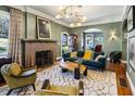 Cozy living room with a fireplace, modern lighting, and stylish furniture at 1696 N Pelham Ne Rd, Atlanta, GA 30324