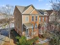 Beautiful townhome with a brick facade, covered porch, and mature trees surrounding the property at 4883 Seldon Se Way, Smyrna, GA 30080