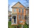 Well-manicured townhome exterior with a covered porch and classic architectural details at 4883 Seldon Se Way, Smyrna, GA 30080