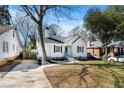 Charming white cottage-style home featuring a covered porch and a long driveway at 1547 Melrose Sw Dr, Atlanta, GA 30310