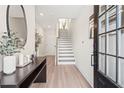 Inviting entryway featuring light wood floors, console table decor, and a staircase leading to the upper level at 1991 Hollywood Nw Rd # 14, Atlanta, GA 30318