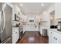 Modern kitchen with white cabinets, stainless steel appliances, and a stylish farmhouse sink at 2005 College Ne Ave, Atlanta, GA 30317