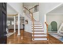 Elegant foyer featuring hardwood floors, a staircase with white risers, and a view into the living area at 569 Alexander Farms Sw Vw, Marietta, GA 30064