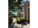Brick home with manicured landscaping, charming walkway, and mature shade tree at 1896 Lake Ridge Ter, Lawrenceville, GA 30043