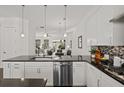 Open kitchen view that showcases the white cabinets, black countertops, stainless steel appliances, and open layout at 4206 Townsend Ln, Atlanta, GA 30346