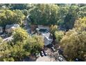 Aerial view of a home nestled among lush green trees with community pool at 1017 Dover Way, Norcross, GA 30093