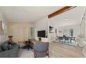 Bright living room featuring a vaulted ceiling with beam, and an open dining area at 130 Valley Rd, Stockbridge, GA 30281