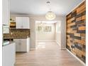 Bright living area featuring luxury floors, a decorative lighting fixture, and a wood accent wall at 1603 Bridgeport Dr, Atlanta, GA 30318