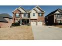 Beautiful two-story home with brick and siding, a two-car garage, and a well-maintained lawn at 980 Yancey Ct, Loganville, GA 30052