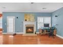 Comfortable living room featuring a cozy fireplace and bright natural light at 980 Yancey Ct, Loganville, GA 30052