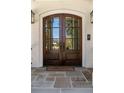 Elegant, arched, wood double doors with glass panels and stone tiling at 18 Blackland Nw Rd, Atlanta, GA 30342