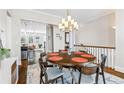 Bright dining room with a modern chandelier, round table with seating for six, and hardwood floors at 2145 Old Georgian Nw Ter, Atlanta, GA 30318