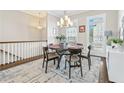 Elegant dining room with natural light, stylish chandelier, and a view of the staircase at 2145 Old Georgian Nw Ter, Atlanta, GA 30318