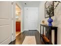 Inviting hallway with hardwood floors, console table, and a glimpse into the bathroom at 44 Peachtree Nw Pl # 829, Atlanta, GA 30309