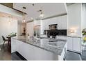 Bright kitchen features a large island with modern lighting and stainless steel appliances at 44 Peachtree Ne Pl # 829, Atlanta, GA 30309