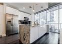 Contemporary kitchen with stainless steel refrigerator and black backsplash, complemented by city views at 44 Peachtree Nw Pl # 829, Atlanta, GA 30309