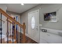 Inviting foyer showcasing hardwood floors, staircase with iron spindles, and a decorative glass front door at 452 Springfield Dr, Woodstock, GA 30188