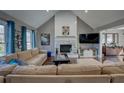 Bright and airy living room boasts a vaulted ceiling, a stone fireplace, and large windows with natural light at 452 Springfield Dr, Woodstock, GA 30188