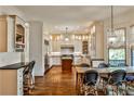 Bright eat-in kitchen featuring custom cabinets, a central island, stone countertops, and hardwood floors at 2805 N Hills Ne Dr, Atlanta, GA 30305