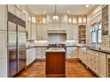 Bright kitchen with custom cabinets, stainless steel appliances, an island, and hardwood floors at 2805 N Hills Ne Dr, Atlanta, GA 30305