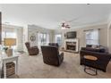 Bright living room boasts neutral tones, a cozy fireplace, and multiple seating arrangements for relaxation and socializing at 6525 Oak Highlands Ct, Cumming, GA 30041