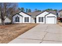 Ranch home with updated vinyl siding, white trim and black shutter accents at 6800 Bells Landing Way, Rex, GA 30273