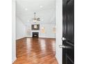Entryway view of a spacious living room featuring hardwood floors and fireplace at 6800 Bells Landing Way, Rex, GA 30273