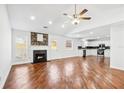 Open concept living room and kitchen with stone fireplace and stainless appliances at 6800 Bells Landing Way, Rex, GA 30273