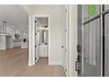 Inviting entryway with light wood floors, leading to an open-concept kitchen and bathroom at 1929 Quarry Park Nw Pl, Atlanta, GA 30318