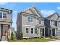 Gray two-story home with well-kept lawn and classic design elements at 1929 Quarry Park Nw Pl, Atlanta, GA 30318