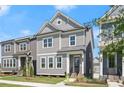 Attractive gray two-story home with manicured lawn, complemented by neighboring houses at 1929 Quarry Park Nw Pl, Atlanta, GA 30318