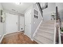 Welcoming foyer with wood floors, staircase, and ample natural light. Freshly painted in gray tones at 330 Cottonwood Creek Cir, Canton, GA 30114