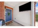 Charming front porch features modern TV, decorative accents, and a welcoming entrance door at 330 Cottonwood Creek Cir, Canton, GA 30114