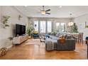 Inviting living room featuring hardwood floors, a comfortable gray sectional, and stylish decor at 10162 Windalier Way, Roswell, GA 30076