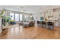 Bright, open-concept living room with hardwood floors, modern furnishings, and plenty of natural light at 10162 Windalier Way, Roswell, GA 30076