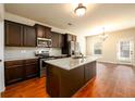 Spacious kitchen with granite countertops, stainless steel appliances, and dark wood cabinets at 103 Magnaview Dr, Mcdonough, GA 30253