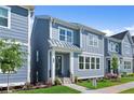 Modern new construction home featuring blue exterior, well-kept lawn, and inviting front entrance at 1937 Quarry Park Nw Pl, Atlanta, GA 30318