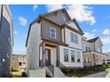 Charming two-story home with stone accents, a covered front porch, and manicured landscaping at 1937 Quarry Park Nw Pl, Atlanta, GA 30318