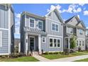 Attractive gray townhome with white accents, a covered entryway, and a lush green lawn at 1941 Quarry Park Nw Pl, Atlanta, GA 30318