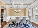 Elegant dining room featuring coffered ceilings, wainscoting, and a bay window for ample natural light at 2040 Browning Bend Ct, Dacula, GA 30019