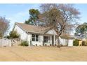 Single story home featuring white siding, a well-kept lawn, and an attached two-car garage at 4820 Roswell Mill Dr, Alpharetta, GA 30022