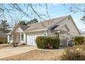 Home with a well-kept lawn, attached garage, white siding, and a neatly trimmed green hedge at 4820 Roswell Mill Dr, Alpharetta, GA 30022