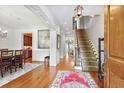 Inviting foyer with hardwood floors, elegant staircase, and view into dining and living areas at 8 Honour Nw Ave # 6, Atlanta, GA 30305