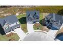 Aerial view of a new construction home in a cul-de-sac with a two car garage and modern design at 1858 Lacebark Elm Way, Lawrenceville, GA 30045